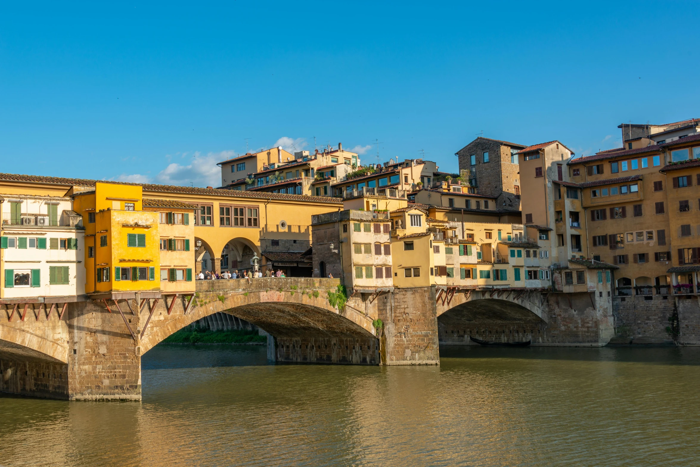 the river is flowing under a bridge in the city