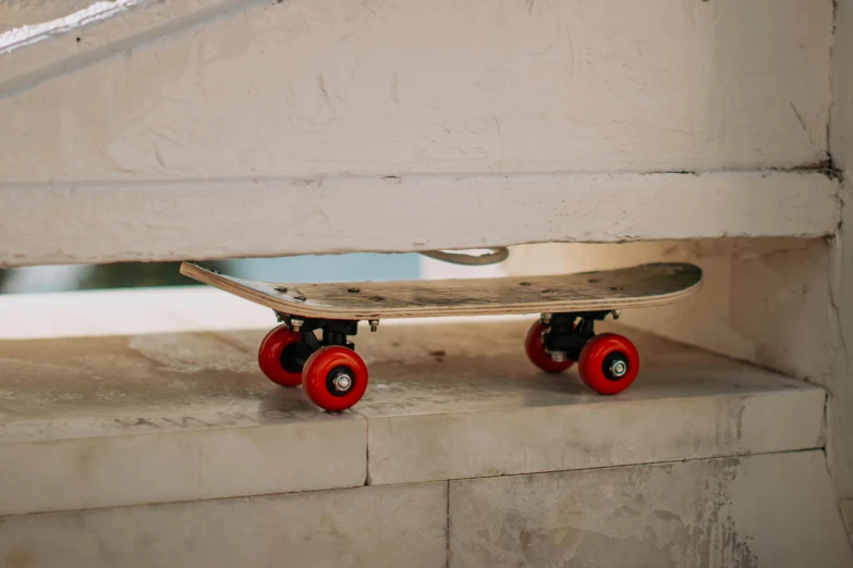 a skateboard is placed in between two red wheels