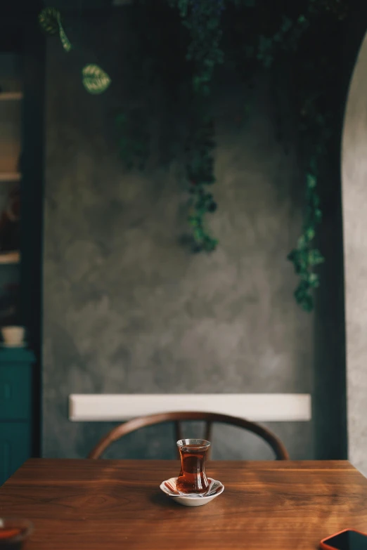 a wooden table topped with a coffee cup and saucer