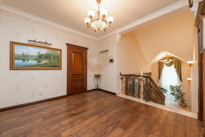 an old foyer with chandelier, picture, and window