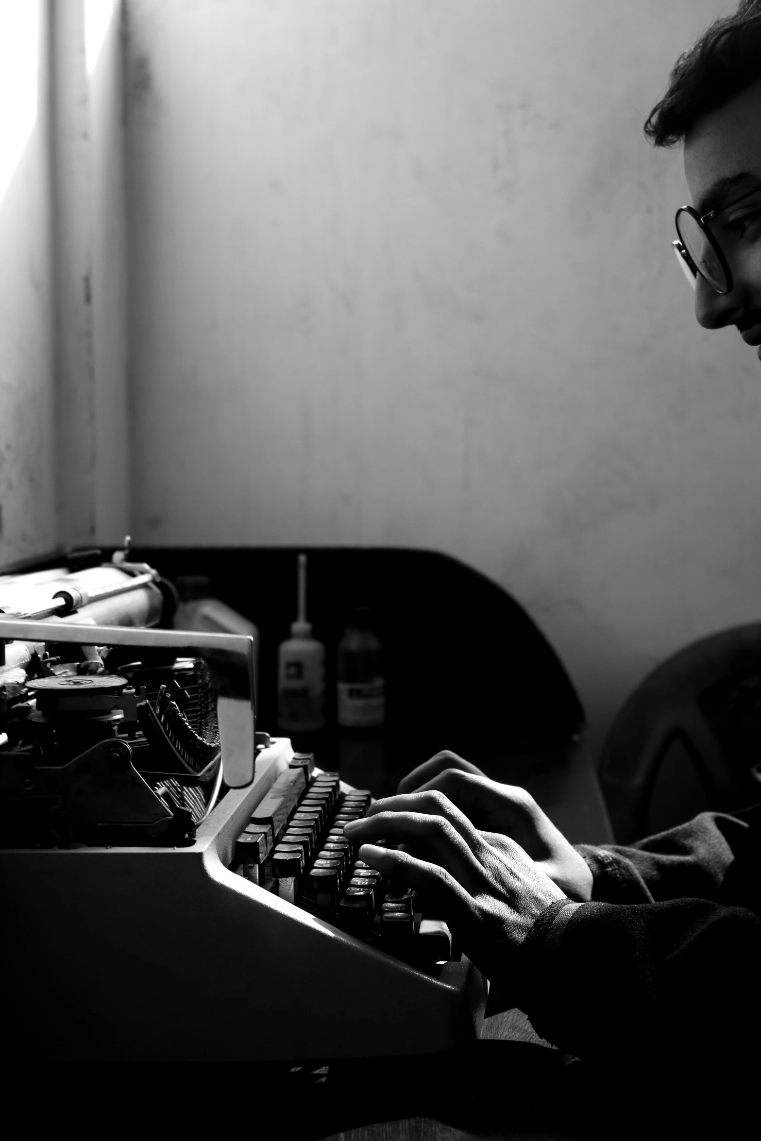 a man is typing on an old fashioned typewriter