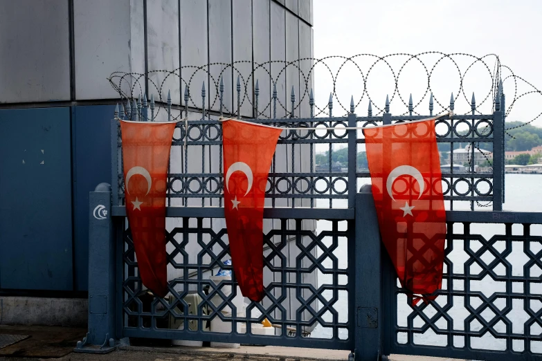 the flag is placed near the metal fence