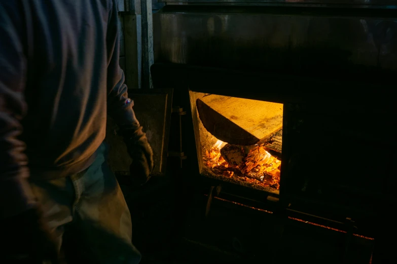 a person is standing next to an oven