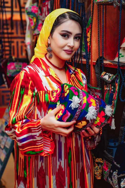 woman standing by a shop displaying ethnic clothing