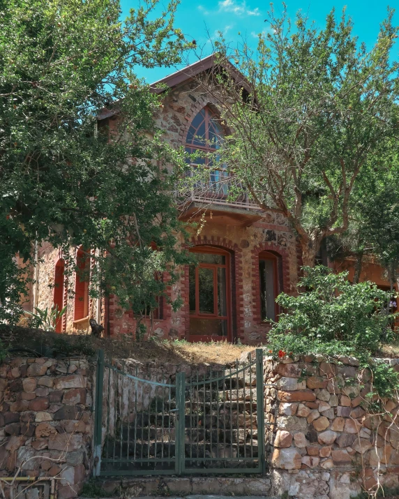 an old brick building with a fenced in front