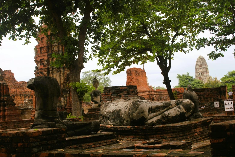 a statue laying down in a ruins