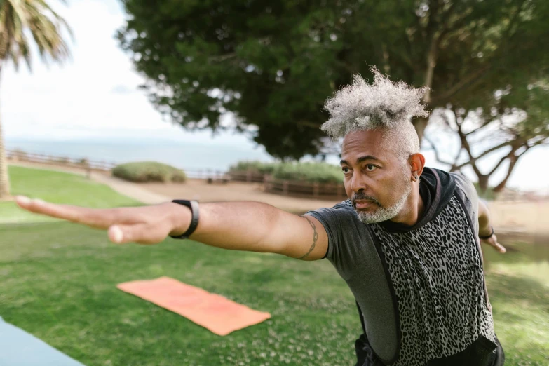 a man who is holding out his arms, to throw a frisbee