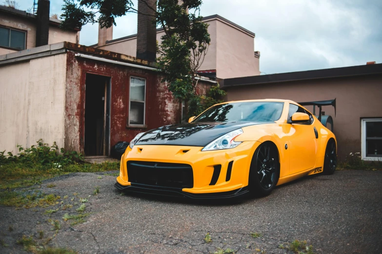 the yellow sports car is parked in front of a building