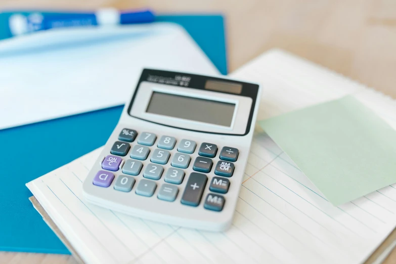 a calculator and some notes on a table