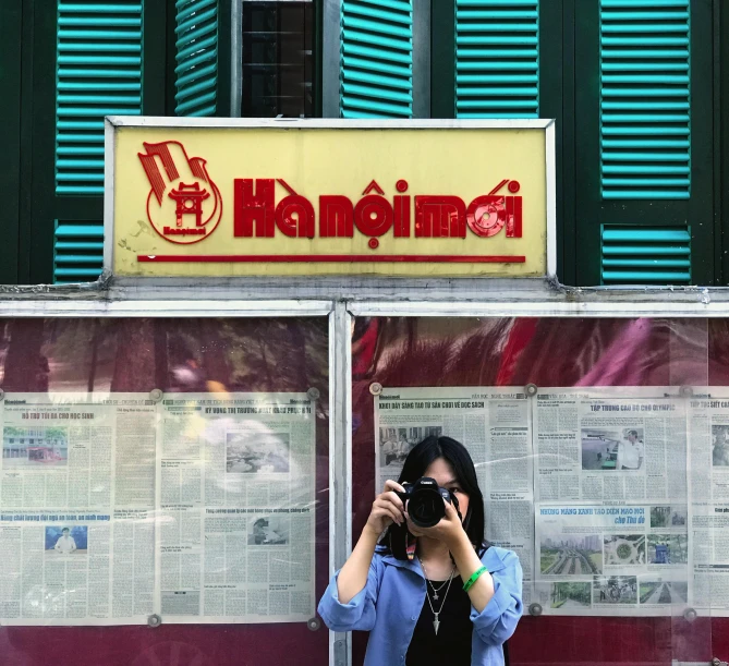 a woman is taking a picture of herself in front of a business