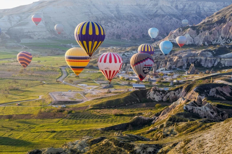 the sky above several large  air balloons