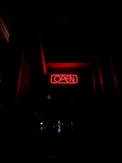 a neon sign reading open lit up on a building