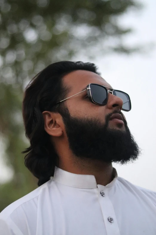 a man with beard and sunglasses on looking up