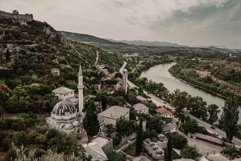 an old european town surrounded by greenery and water