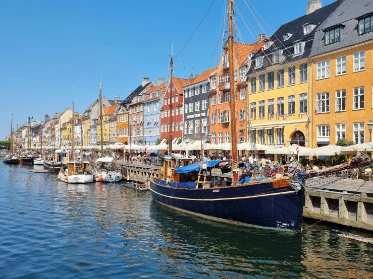 a body of water with boats near buildings