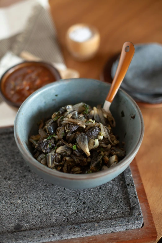 a bowl on top of a table filled with food