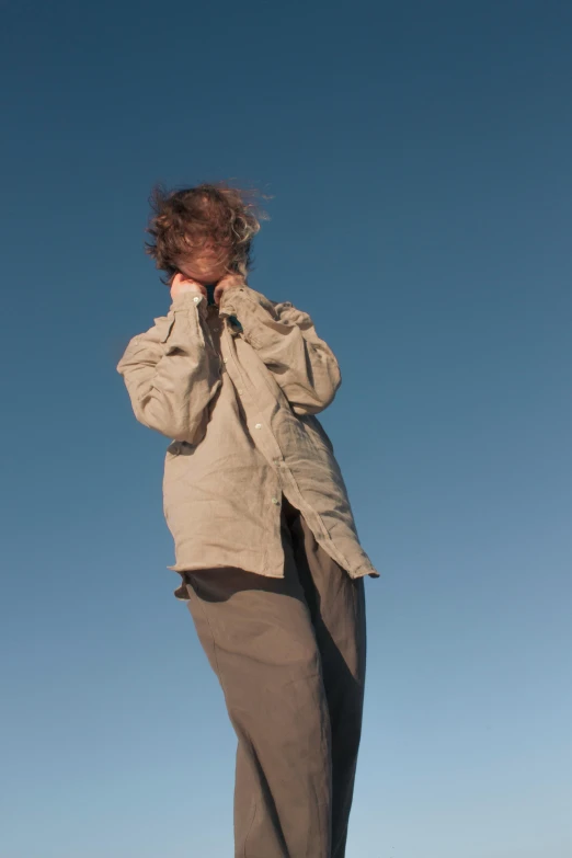 a woman standing next to a car on the side of a hill