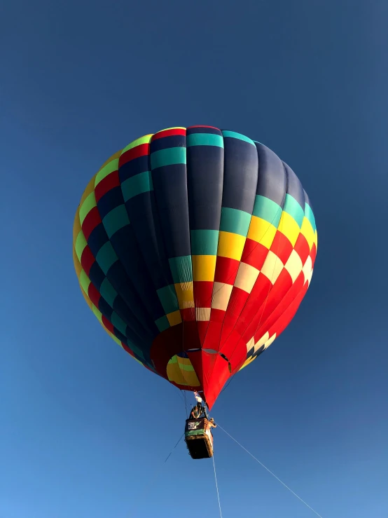 a large colorful  air balloon is in the sky
