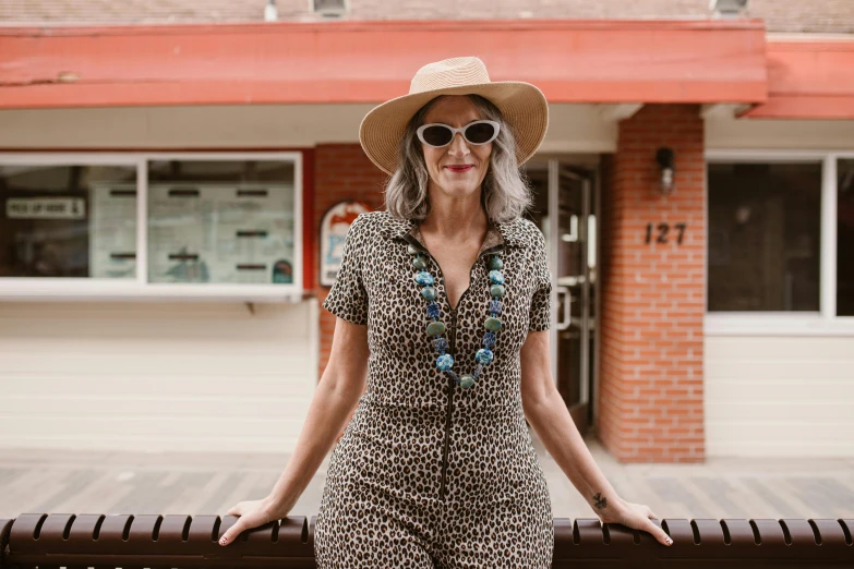 a woman in sunglasses and a leopard print jumpsuit