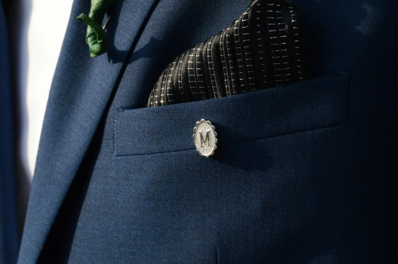 the on on the side of a suit jacket is marked with a circular