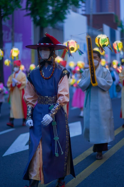 people wearing costumes on a city street