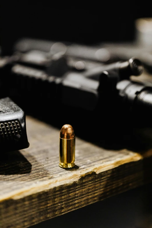 a bullet is next to a laptop and some other accessories