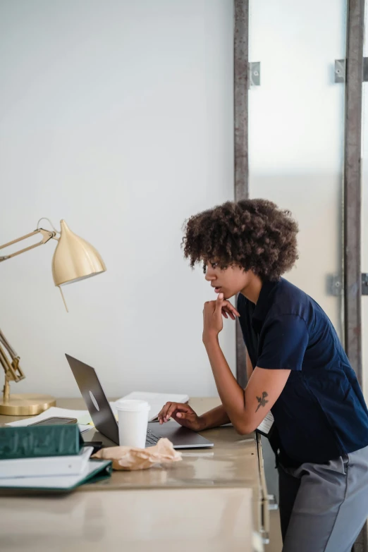 a person with a laptop is at a desk