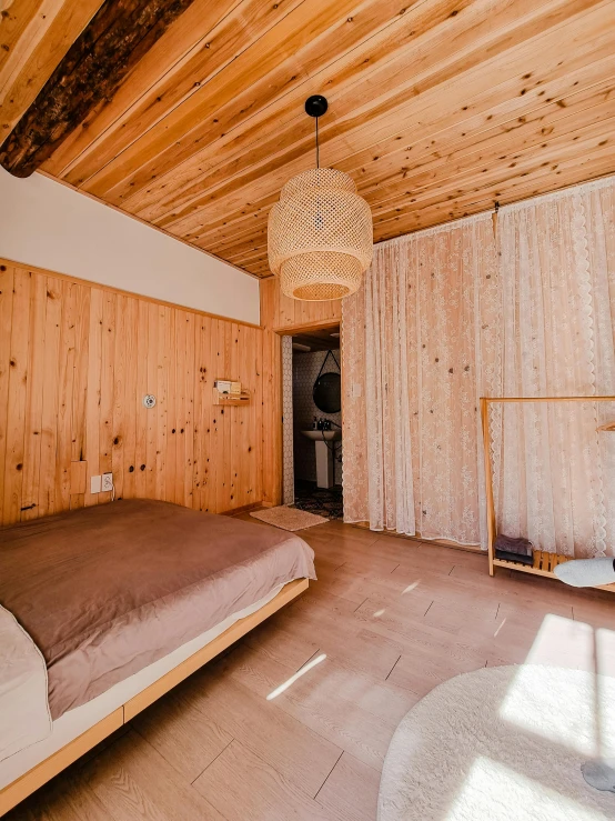 large wooden bedroom with wood paneling on the walls