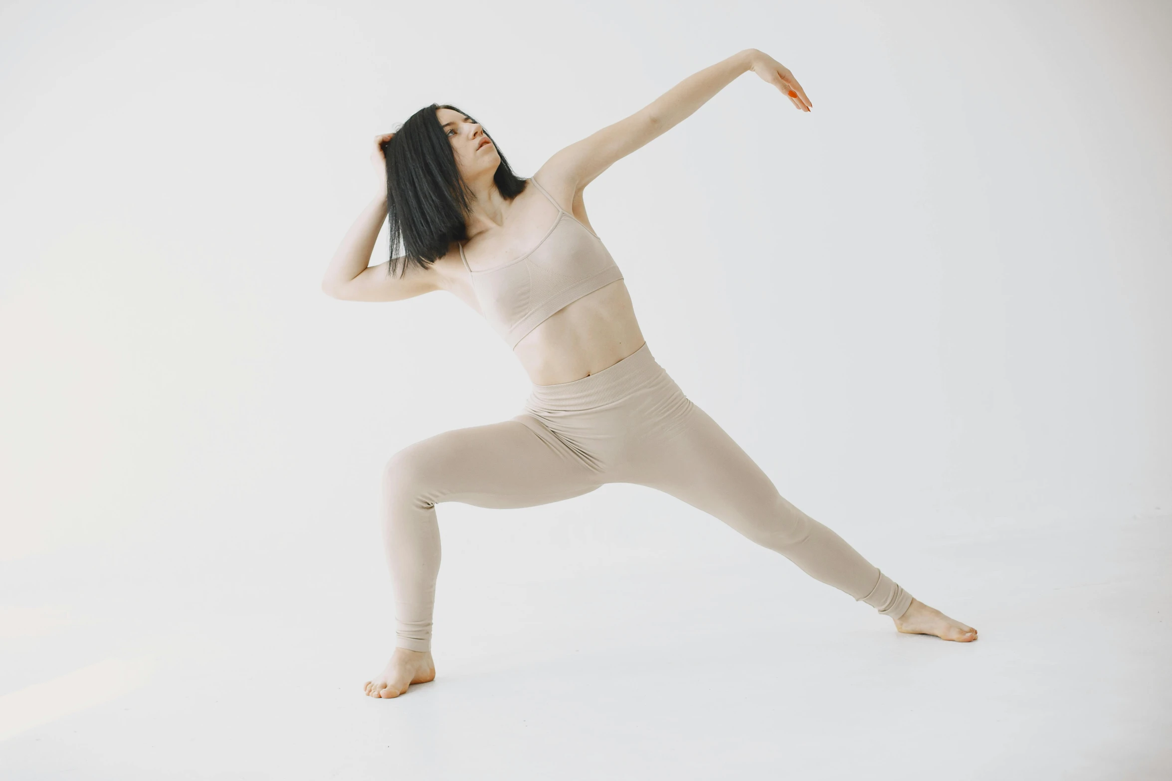 a woman with her arm raised up in the air