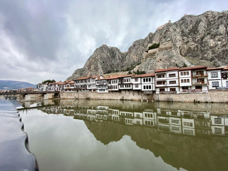 houses on a rocky shore next to the water