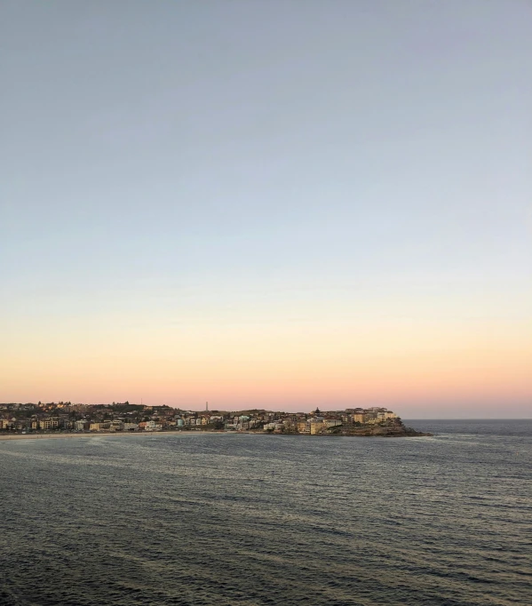 an island and the horizon line with a town in the distance