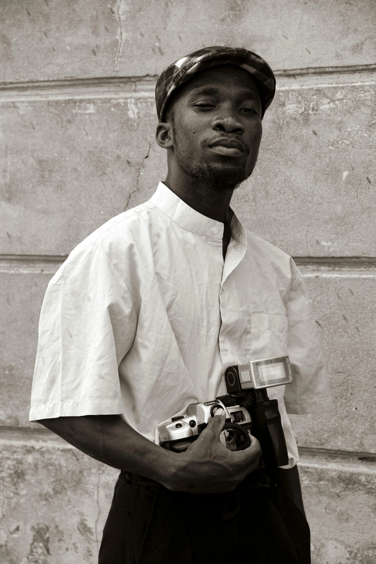 a man in a baseball cap is holding a remote controller