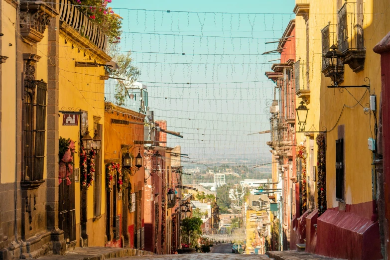 a street with buildings and a number of electrical wires above them