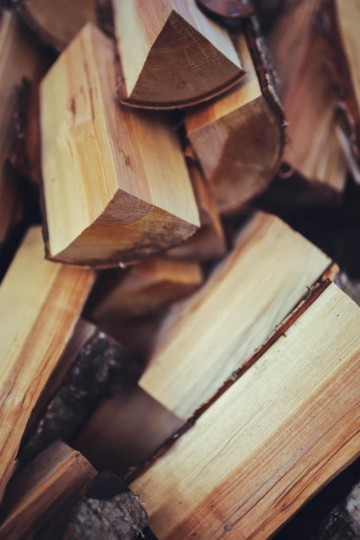 many pieces of wood sit together in a pile