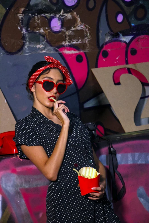 a woman with a bow and red sunglasses