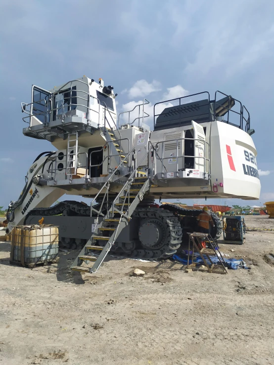 a large machine is sitting on the beach