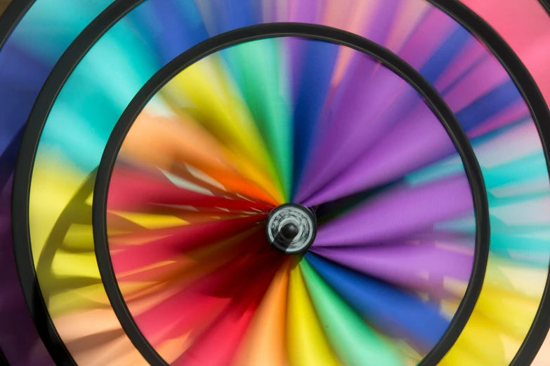 a multi colored rainbow spinning device with no wheels