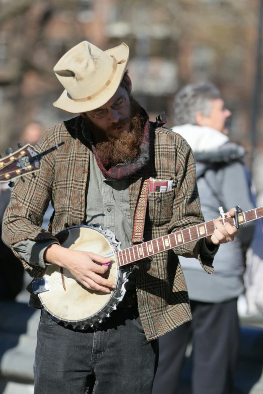 the man is playing his banjo and guitar