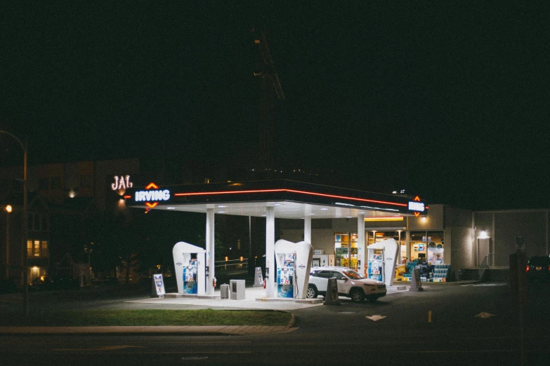 a car is parked next to a gas station