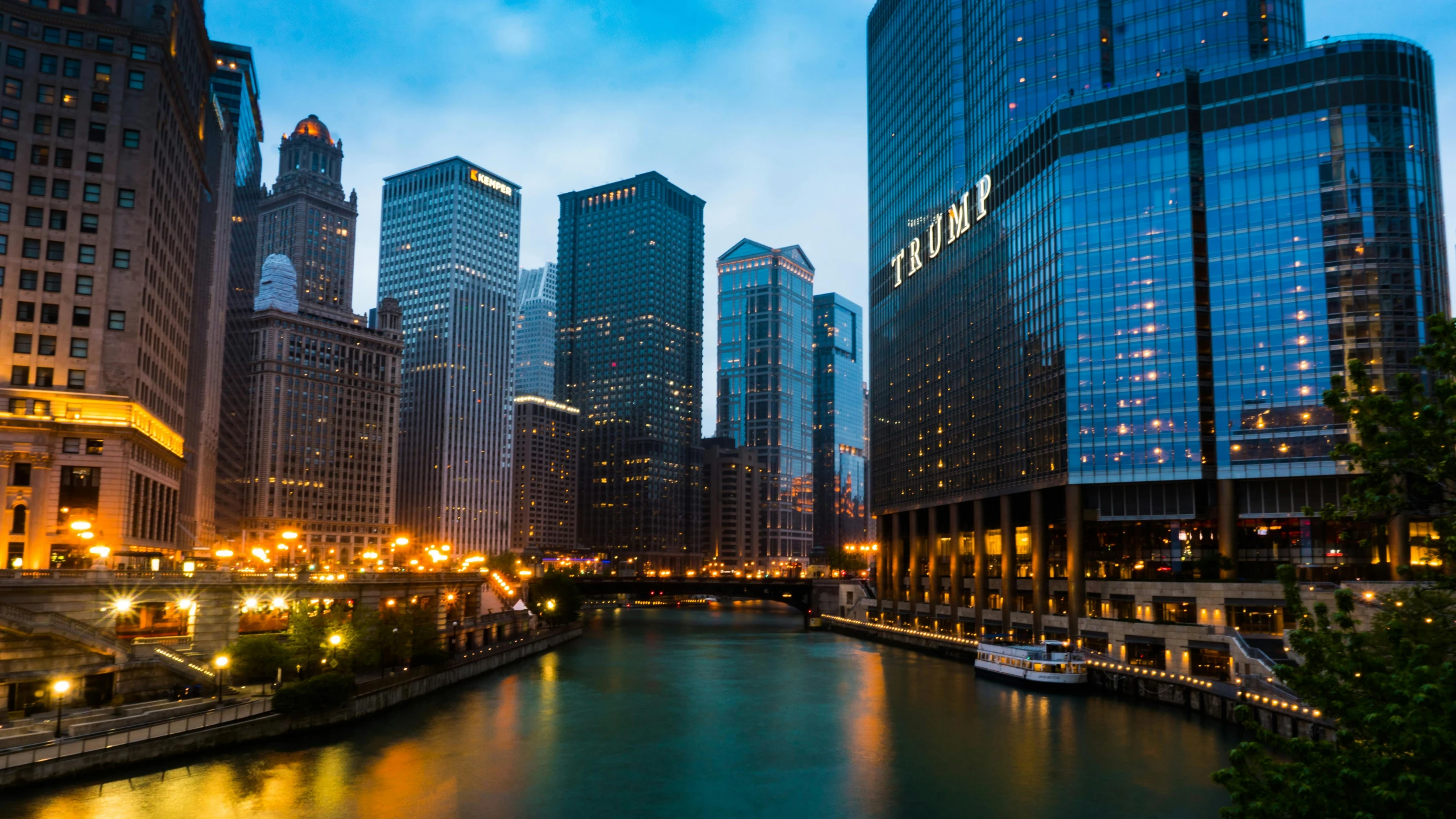 the lights shine on buildings along the water