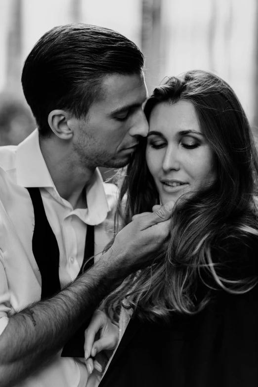 man feeding his brides hair while they are smiling