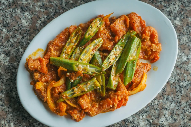 cooked food with asparagus and sauce served on a plate