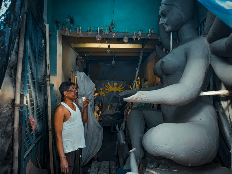 the woman is looking into the display of statues