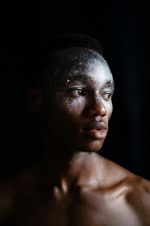 a man with black hair and  wearing a white face mask