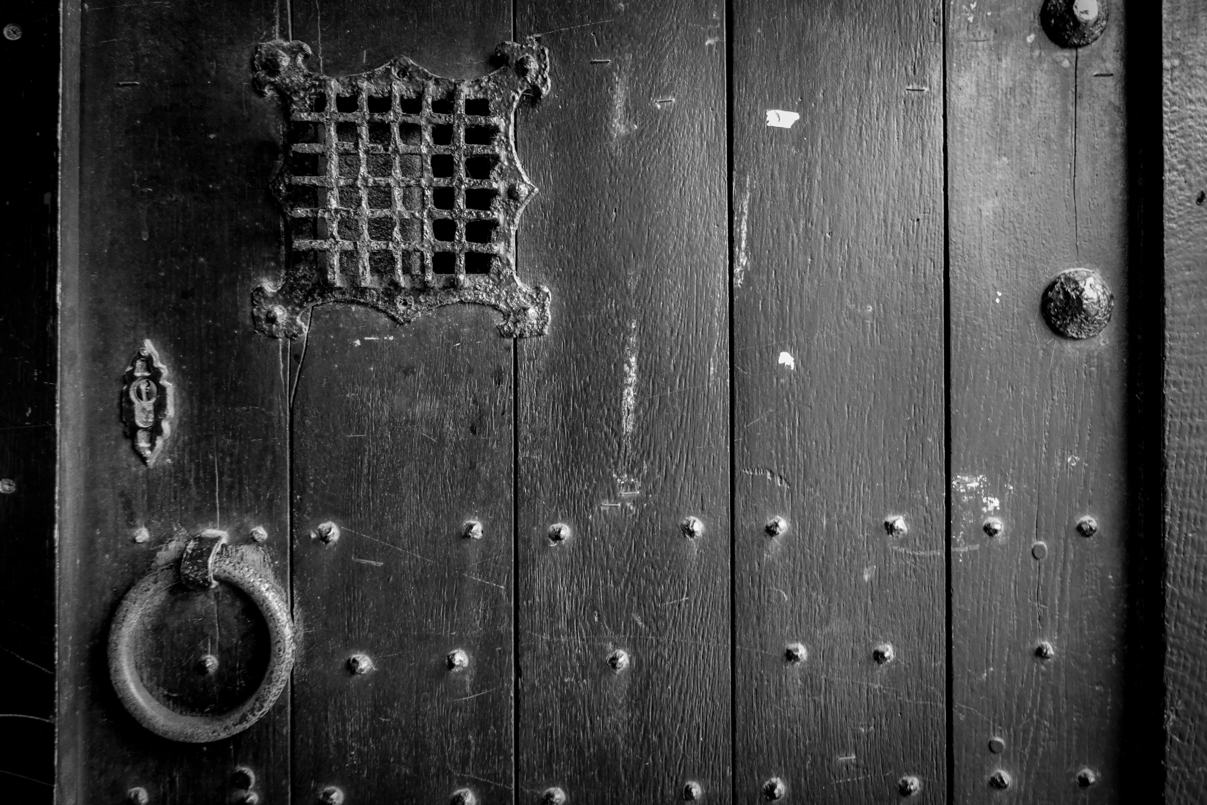 the old wooden door has round metal s