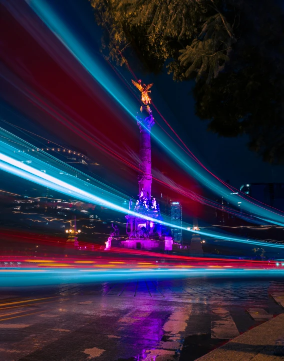 colorful lights streak across the dark city at night