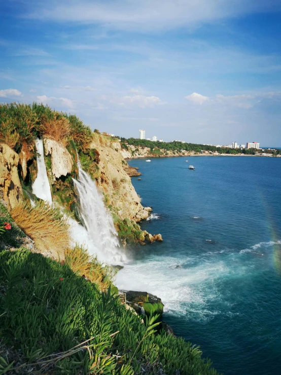 view of the ocean from the cliff side of a town