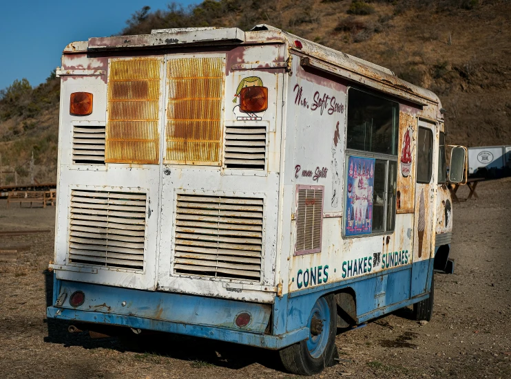 a truck is parked on dirt in the desert