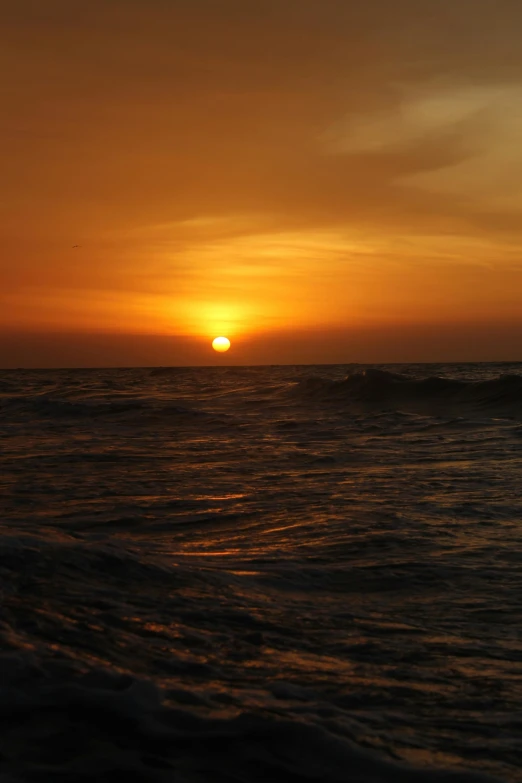 a sunset that is reflecting the sun in water