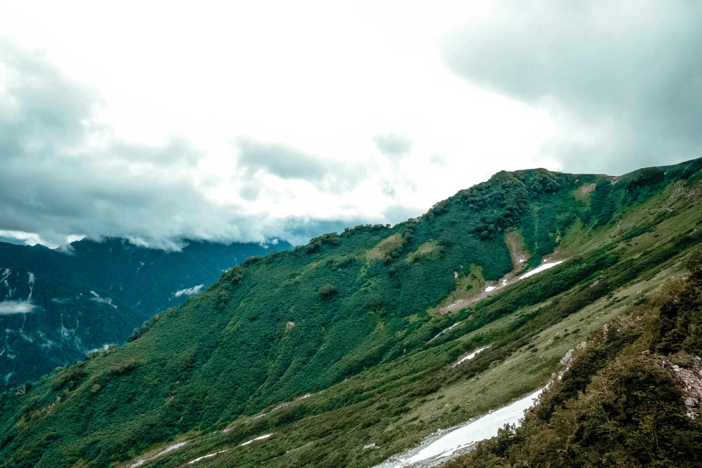 the mountains are steep, covered with snow